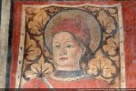 Détail du visage de Saint Pantaléon coiffé d’un bonnet rouge